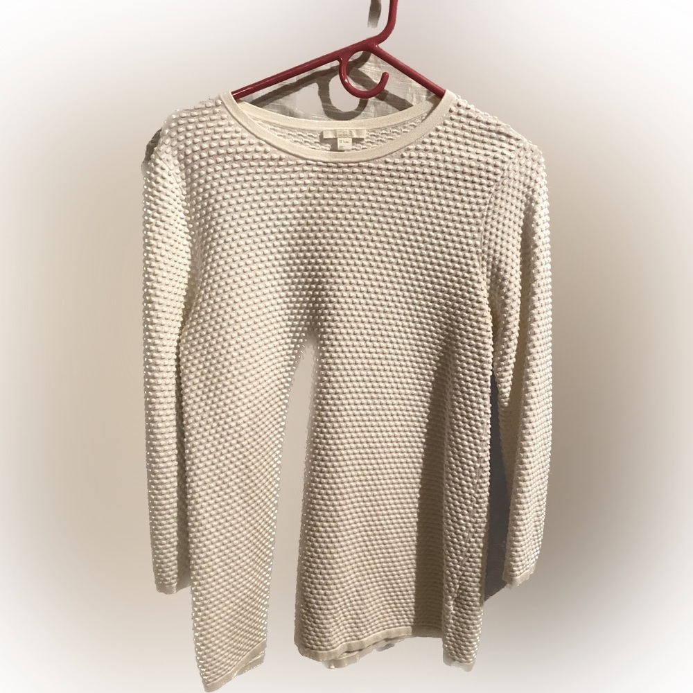 Long sleeve, medium weight, patterned white on white knit fabric shirt.
